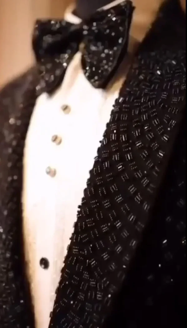 "Black tuxedo jacket embellished with shimmering black crystals"